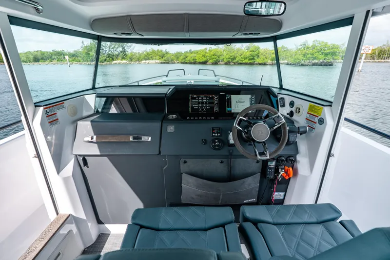 Slide: The Image of Interior view of 2022 Axopar 37 XC Cross Cabin boat cockpit with modern controls. - 33