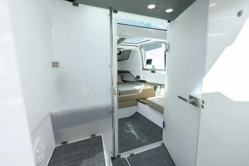 Slide: The Image of Interior view of 2022 Axopar 37 XC Cross Cabin, featuring modern seating and sleek design. - 38