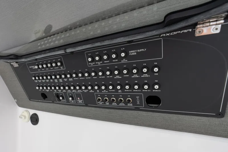Slide: The Image of Control panel of 2022 Axopar 37 XC Cross Cabin, featuring various switches and fuses. - 40