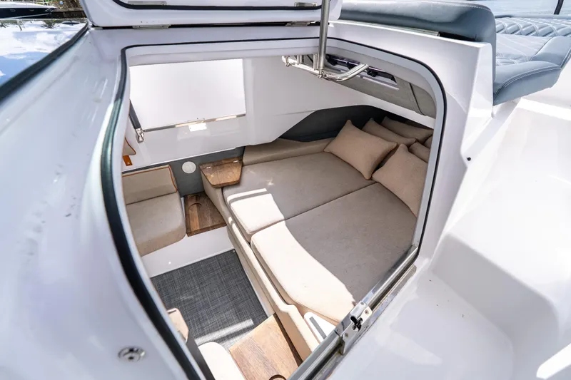 Slide: The Image of Interior cabin of 2022 Axopar 37 XC Cross Cabin, featuring cozy seating and cushions. - 43
