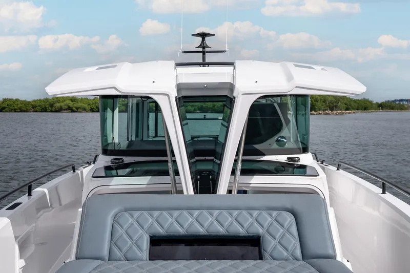Slide: The Image of 2022 Axopar 37 XC Cross Cabin boat on calm water, featuring sleek design and modern cabin. - 44