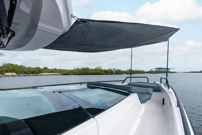 Slide: The Image of 2022 Axopar 37 XC Cross Cabin boat with sunshade on calm water. - 45