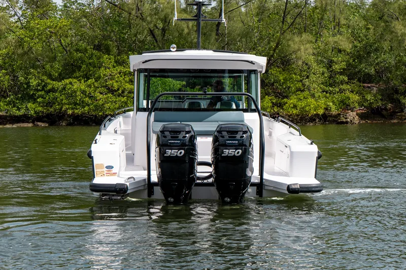 Slide: The Image of 2022 Axopar 37 XC Cross Cabin with dual 350 engines on water. - 5