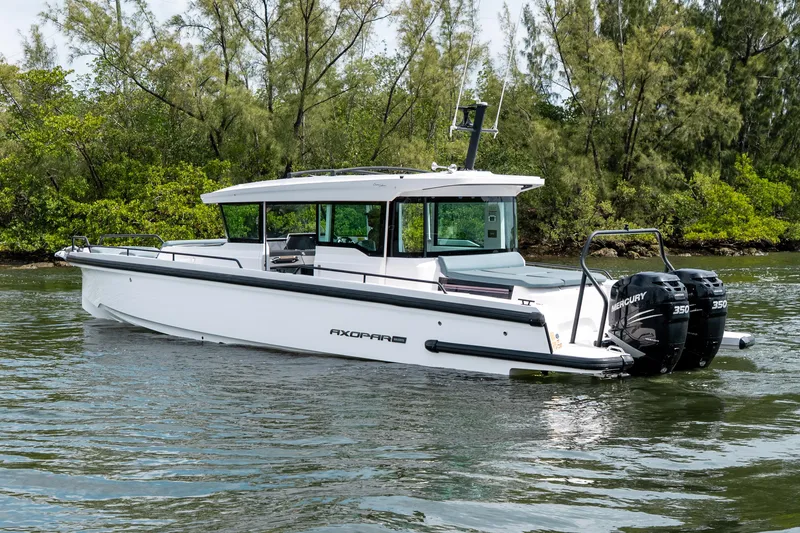 Slide: The Image of 2022 Axopar 37 XC Cross Cabin boat on water, featuring dual Mercury 350 engines. - 6