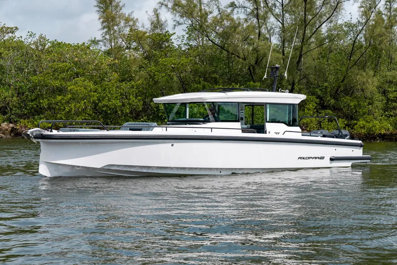 Slide: The Image of 2022 Axopar 37 XC Cross Cabin boat cruising on a calm waterway. - 8