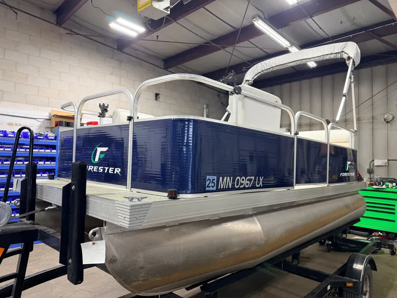 Slide: The Image of 2019 Forester 14' pontoon boat in warehouse, blue design. - 26