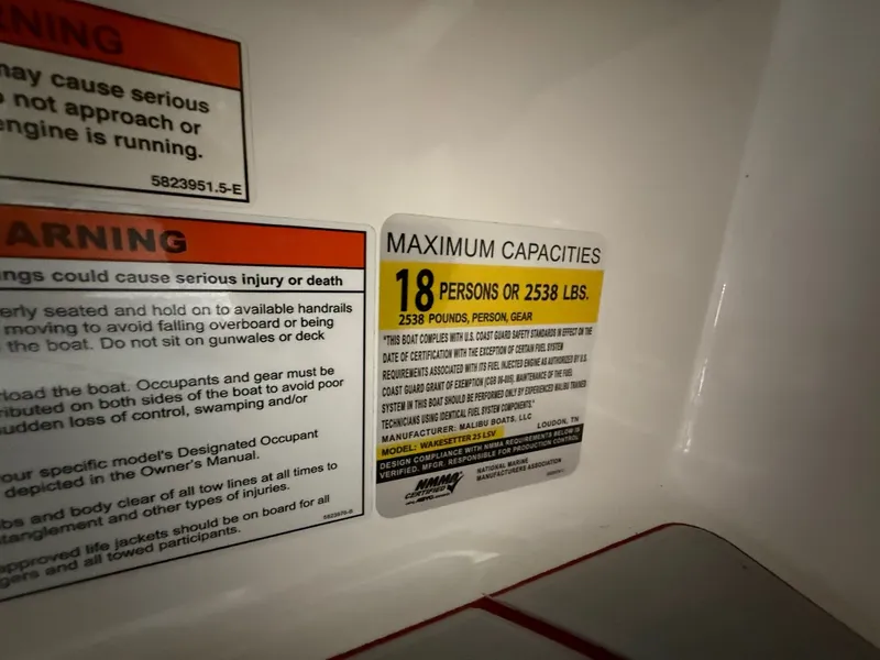Slide: The Image of Warning and capacity labels on 2022 Malibu Wakesetter 25 LSV. - 10