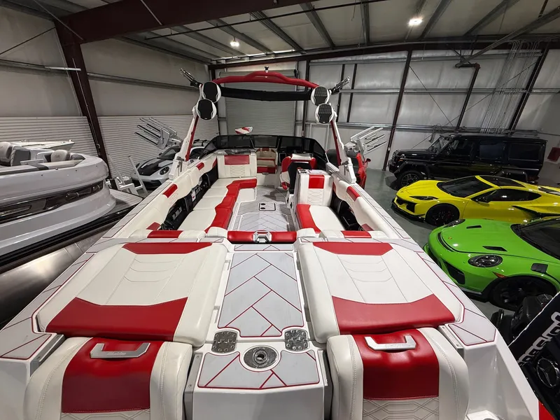 Slide: The Image of 2022 Malibu Wakesetter 25 LSV boat with luxurious red and white interior. - 6