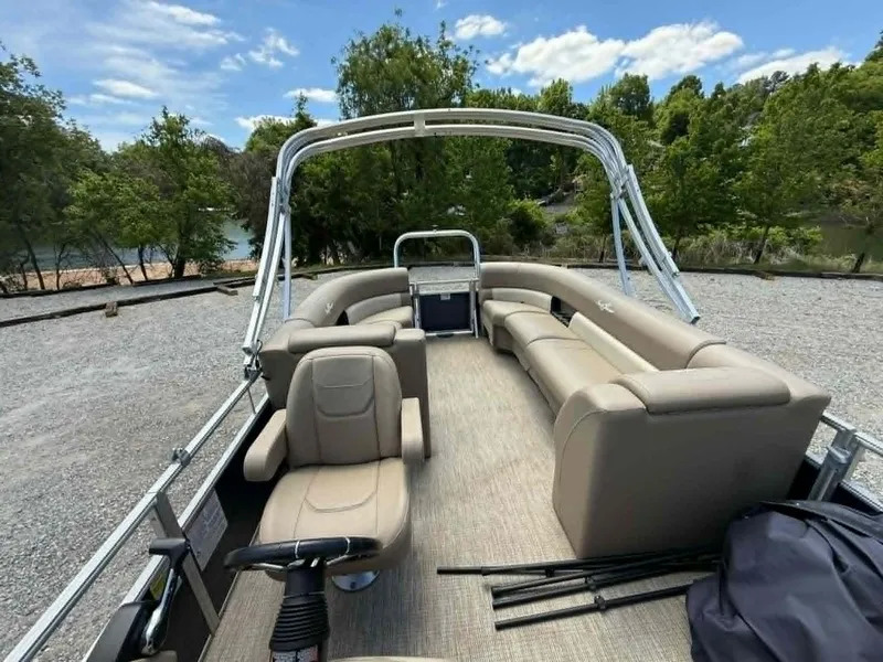 Slide: The Image of 2023 SunChaser Vista 22 LR pontoon boat with beige seating outdoors. - 24