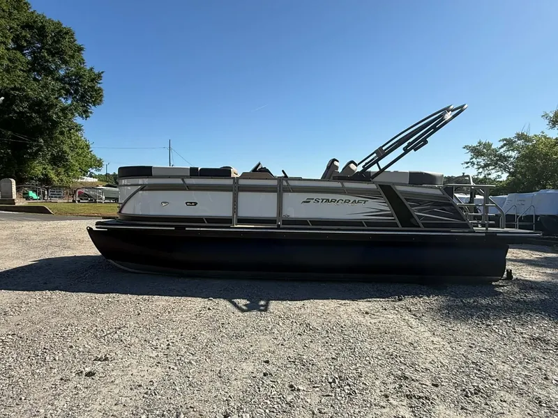 Slide: The Image of Starcraft SLS-1 R 2026 pontoon boat on gravel lot under sunny sky. - 5