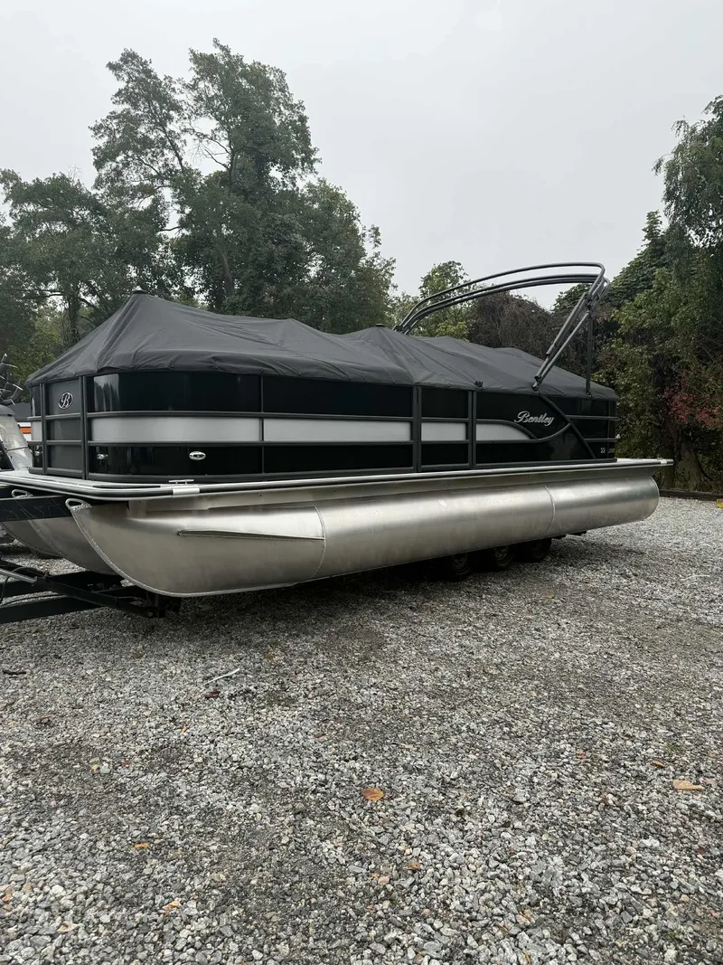 Slide: The Image of 2026 Bentley Pontoons Legacy 223 Navigator parked on gravel surface. - 10