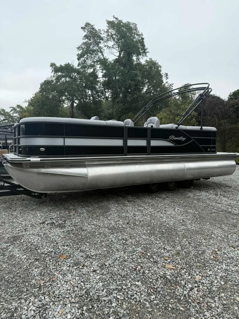 Slide: The Image of 2026 Bentley Pontoons Legacy 223 Navigator parked on gravel surface. - 9