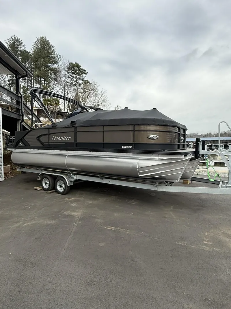 The Image of 2026 Manitou 23 Encore SLVPII pontoon boat on trailer. - 1