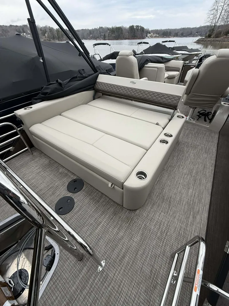 Slide: The Image of Interior of 2026 Manitou 23 Encore SLVPII with luxurious seating. - 14