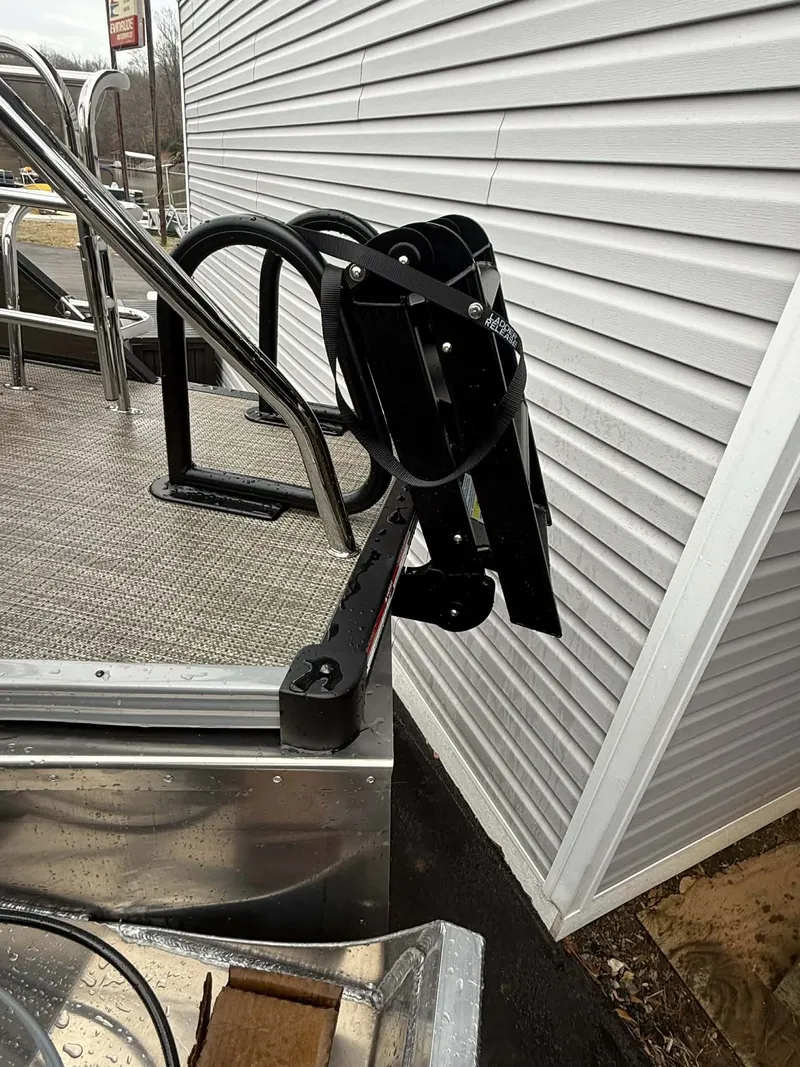 Slide: The Image of Manitou 23 Encore SLVPII 2026 with black outboard motor. - 15