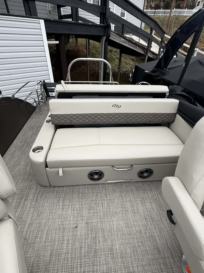 Slide: The Image of Interior of 2026 Manitou 23 Encore SLVPII with beige seating area. - 21