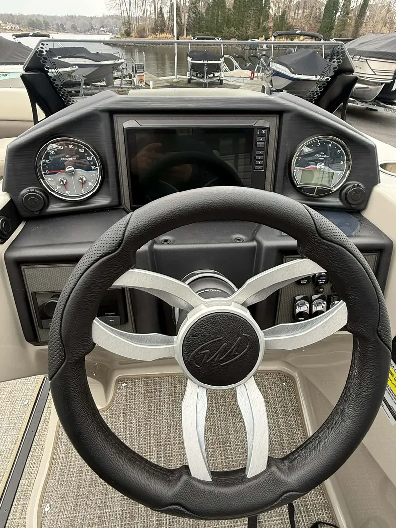 Slide: The Image of 2026 Manitou 23 Encore SLVPII steering console with gauges. - 25