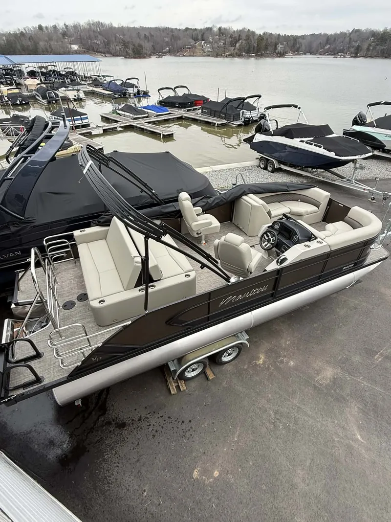 Slide: The Image of 2026 Manitou 23 Encore SLVPII pontoon boat at dock. - 9