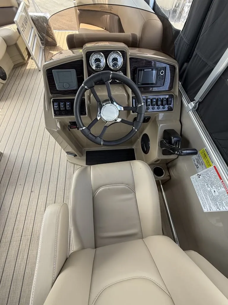 Slide: The Image of 2025 Sylvan Mirage 8524 Resorter helm with steering wheel and controls. - 11