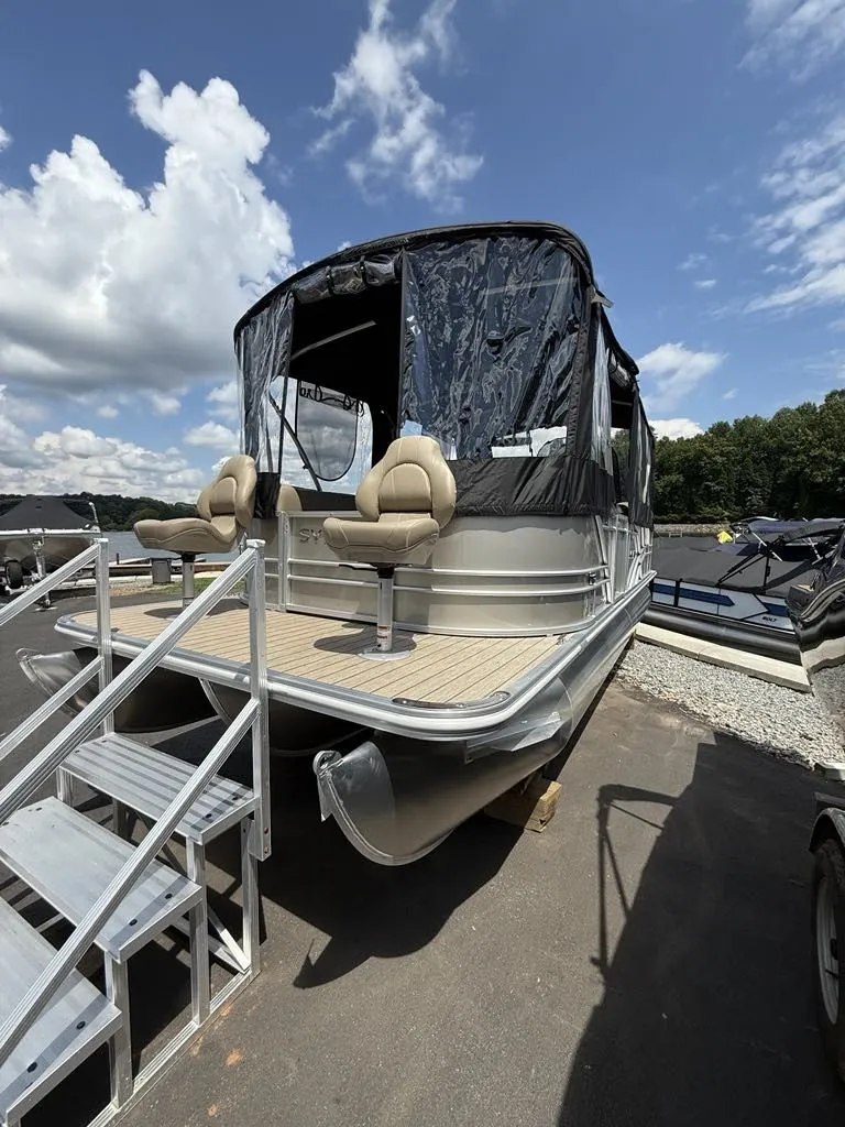 Slide: The Image of 2025 Sylvan Mirage 8524 Resorter pontoon boat on a parking lot. - 7