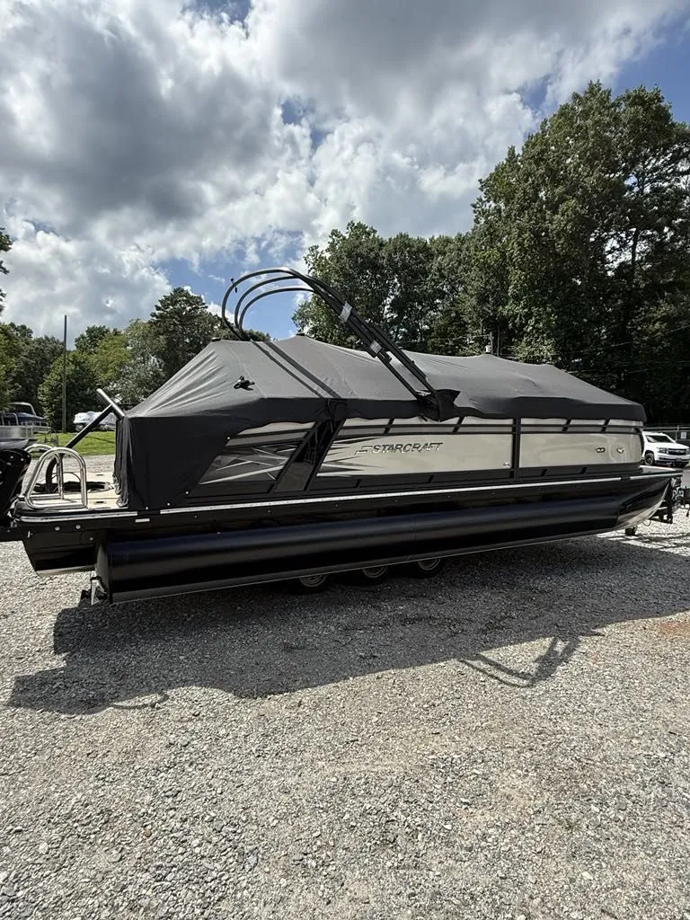 Slide: The Image of Starcraft SLS-3 2025 pontoon boat with cover on gravel lot. - 7