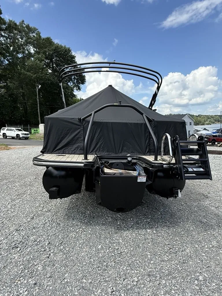 Slide: The Image of Starcraft SLS-3 2025 pontoon boat with cover on gravel lot. - 8