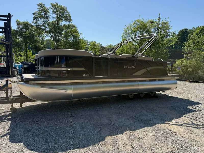 Slide: The Image of 2025 Sylvan L-3 Party Fish pontoon boat on gravel lot. - 17