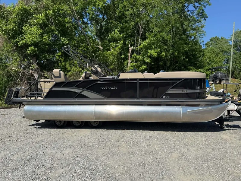 Slide: The Image of 2025 Sylvan L-3 Party Fish pontoon boat parked outdoors. - 36