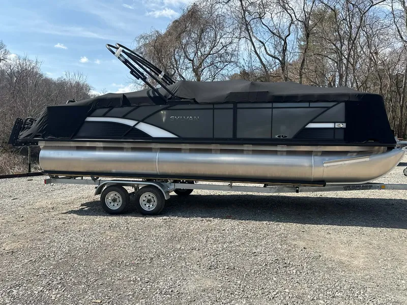 Slide: The Image of 2026 Sylvan L-3 LZ DH pontoon boat on trailer outdoors. - 13