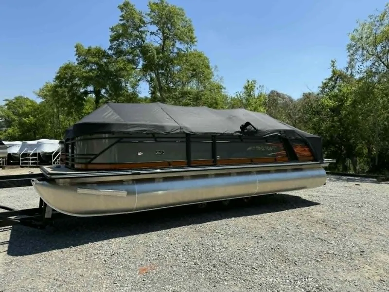 Slide: The Image of 2025 Starcraft SLS-3 pontoon boat with cover on gravel lot. - 11