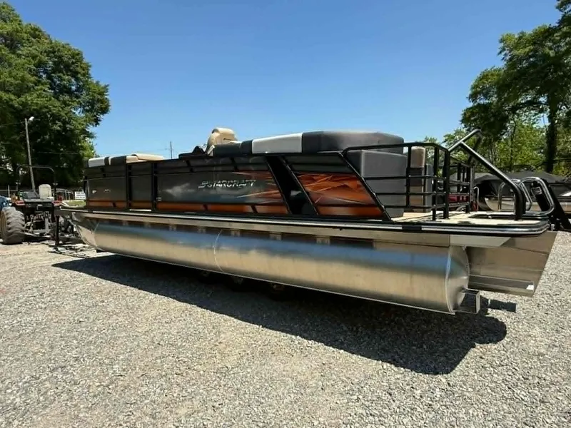 Slide: The Image of 2025 Starcraft SLS-3 pontoon boat on gravel lot under sunny skies. - 21
