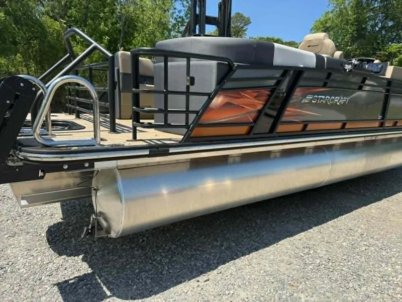 Slide: The Image of 2025 Starcraft SLS-3 pontoon boat on gravel surface, side view. - 27