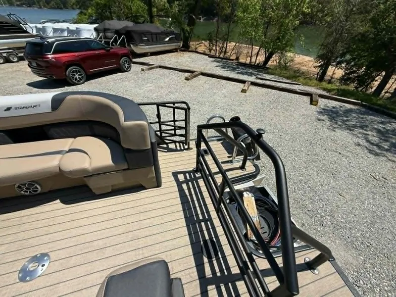 Slide: The Image of Starcraft SLS-3 2025 pontoon boat parked by lakeside. - 5