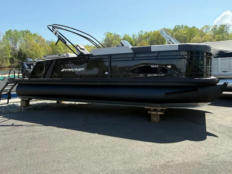 The Image of 2026 Starcraft SLS-3 DL DH Bar pontoon boat on a parking lot. - 1