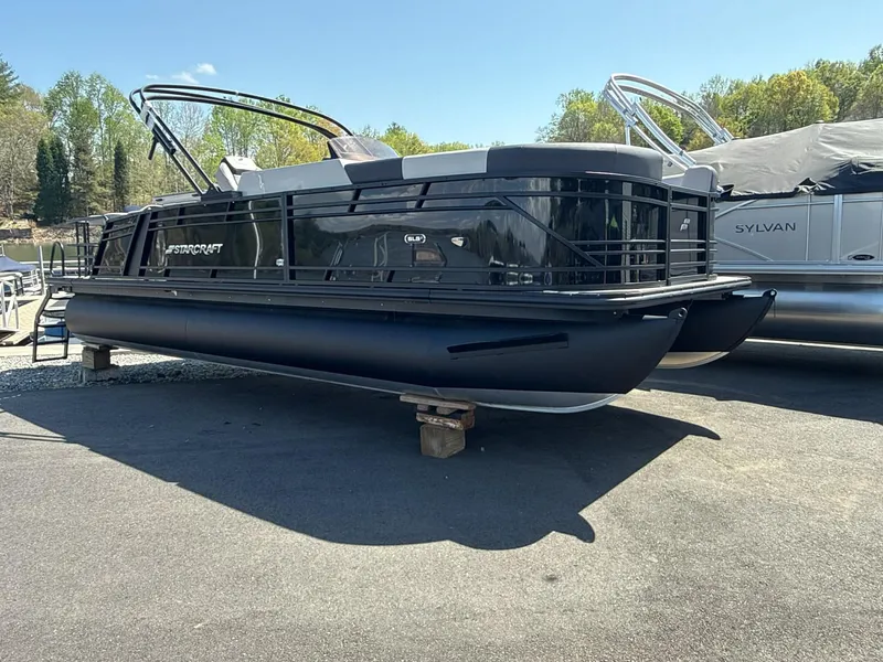 Slide: The Image of Starcraft SLS-3 DL DH Bar pontoon boat, 2026 model, on a parking lot. - 9