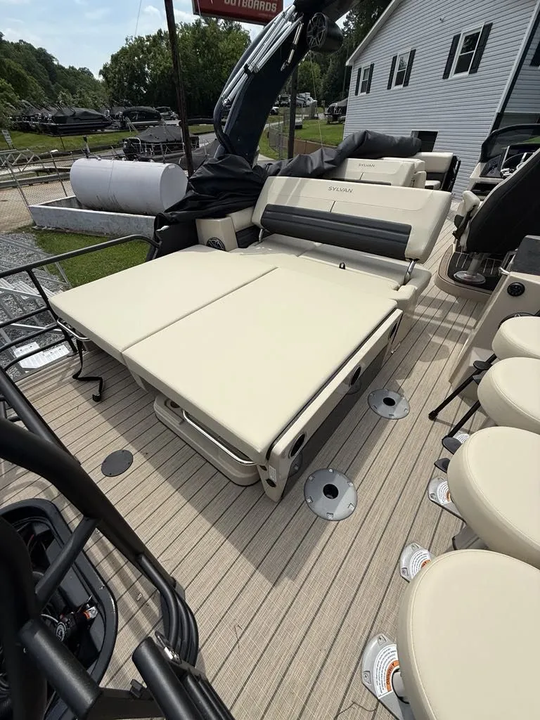 Slide: The Image of Sylvan G3 DLZ Bar 2025 with beige lounge seating on boat. - 14