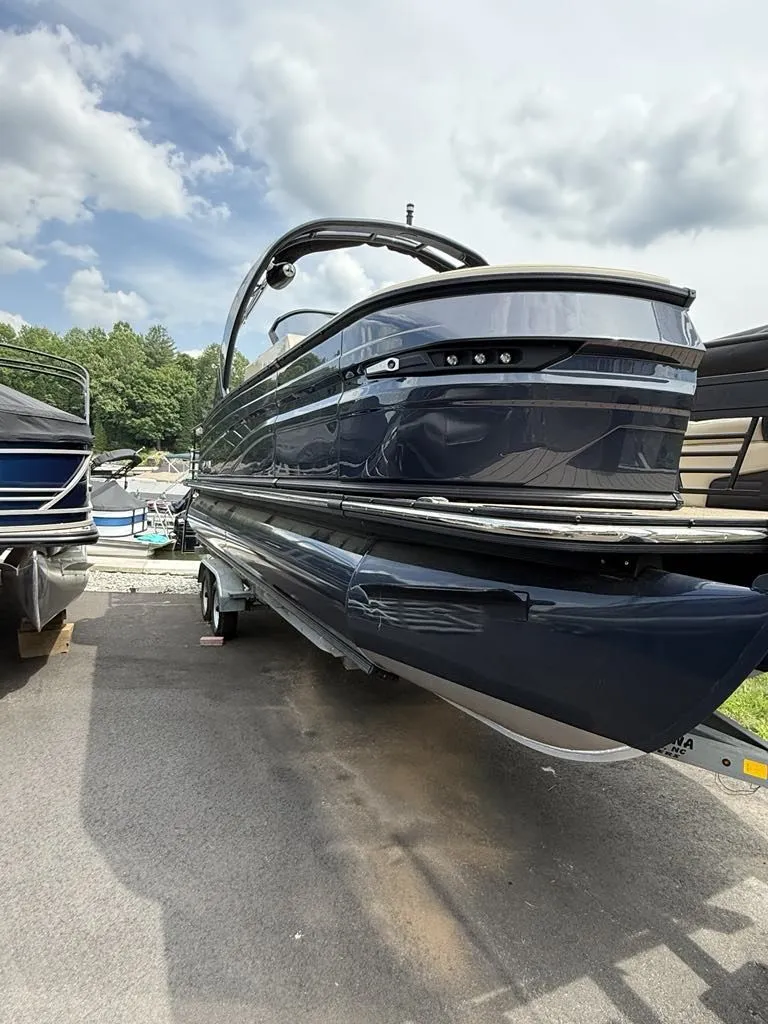 Slide: The Image of 2025 Sylvan G3 DLZ Bar pontoon boat on a trailer. - 3