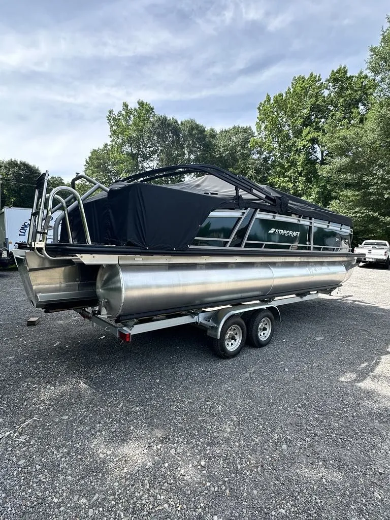 Slide: The Image of 2024 Starcraft CX 23 Q DH pontoon boat on trailer outdoors. - 4