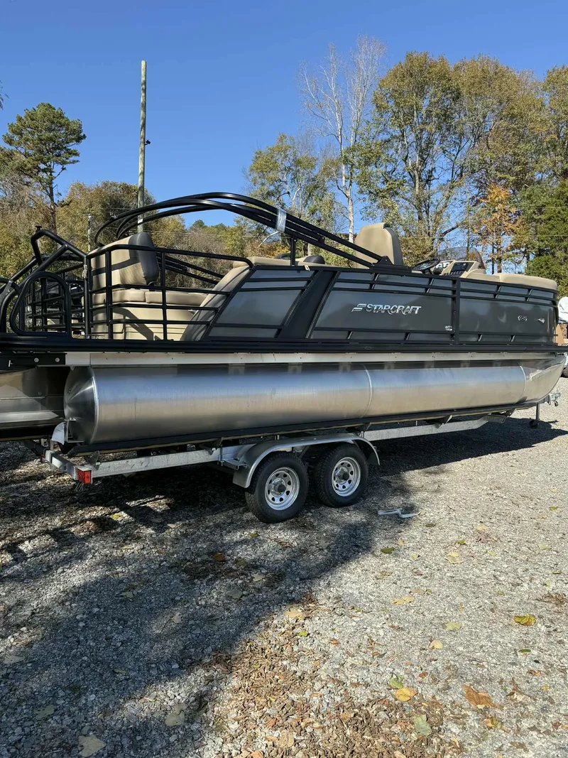 The Image of 2026 Starcraft EXS-3 DL pontoon boat on trailer outdoors. - 1