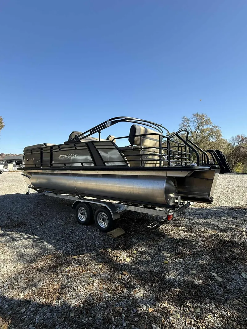 Slide: The Image of Starcraft EXS-3 DL 2026 pontoon boat on trailer outdoors. - 14
