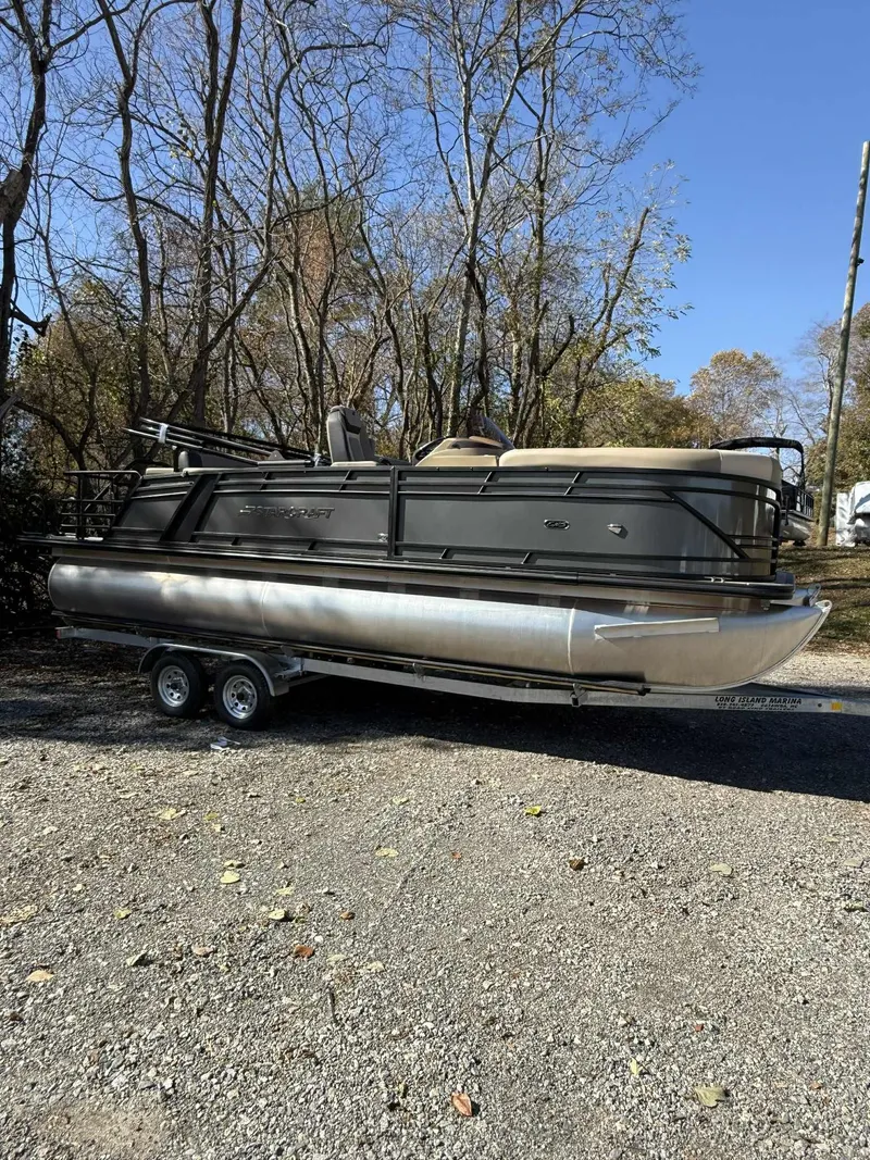 Slide: The Image of 2026 Starcraft EXS-3 DL pontoon boat on trailer outdoors. - 16