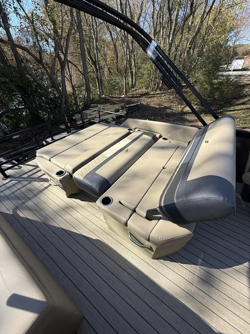 Slide: The Image of Starcraft EXS-3 DL 2026 pontoon boat with beige seating outdoors. - 4