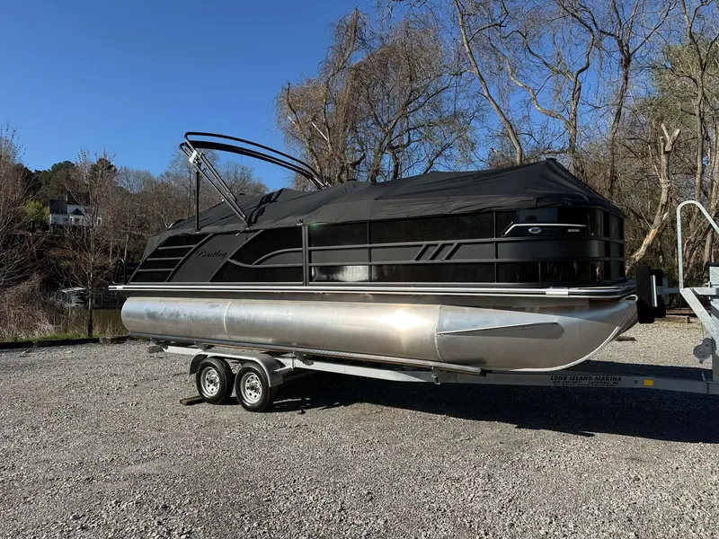 Slide: The Image of 2026 Bentley Pontoons Elite 223 Admiral on trailer, covered, parked outdoors. - 3