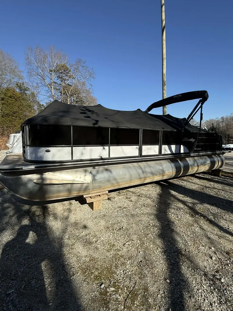 Slide: The Image of 2023 Bentley Pontoons Legacy 243 Swingback on gravel surface. - 4