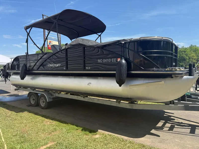 The Image of 2017 Starcraft MX 25 pontoon boat on trailer, black canopy. - 1