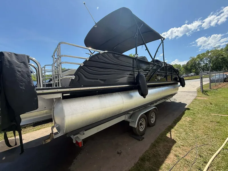 Slide: The Image of 2017 Starcraft MX 25 pontoon boat on trailer in sunny weather. - 11