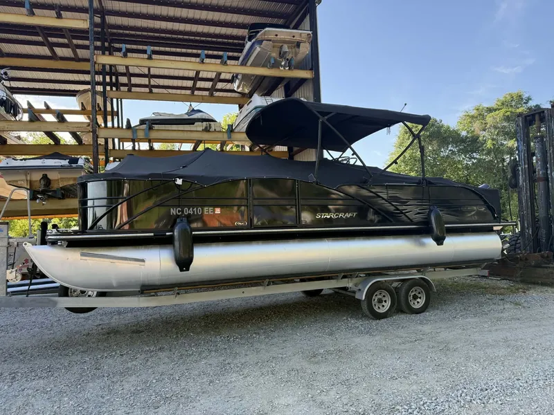 Slide: The Image of 2017 Starcraft MX 25 pontoon boat on trailer in storage. - 12