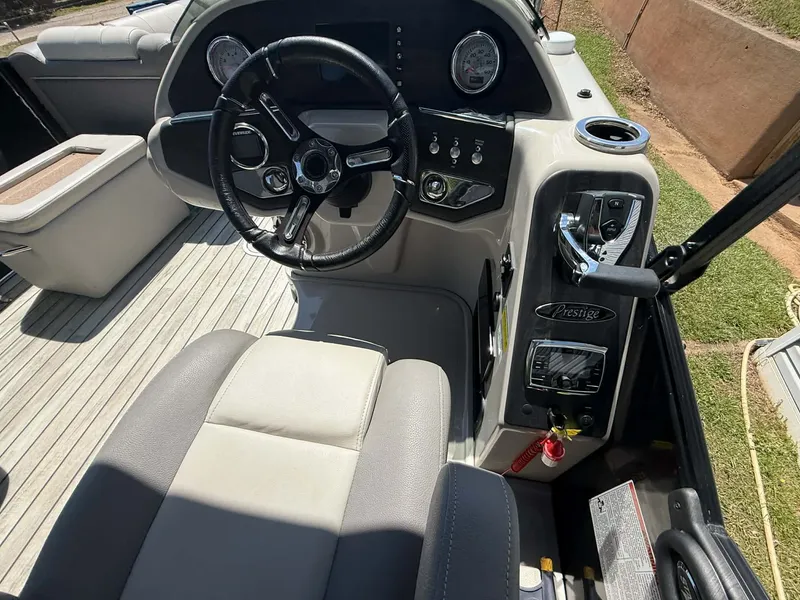 Slide: The Image of Interior of a 2017 Starcraft MX 25 boat with steering console. - 15