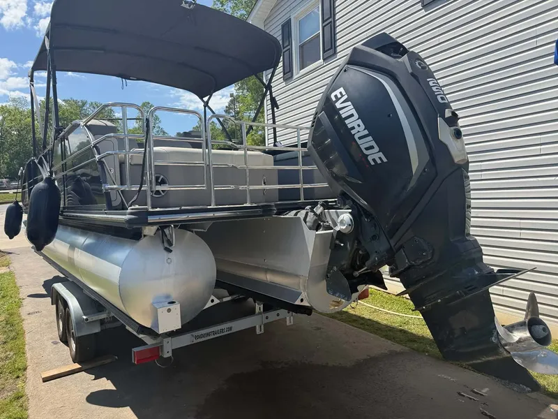 Slide: The Image of 2017 Starcraft MX 25 pontoon boat with Evinrude motor on trailer. - 17