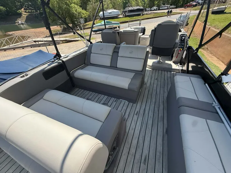 Slide: The Image of Interior of a 2017 Starcraft MX 25 pontoon boat with gray seating. - 19